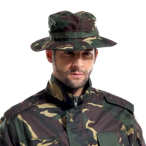 Person wearing a woodland camo TactShield sun hat with a webbing band around the crown