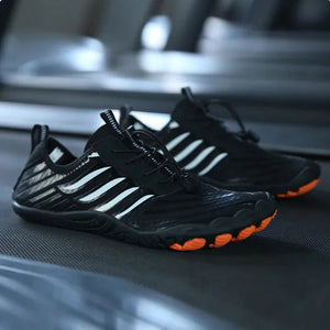 Elite Fusion 7 barefoot shoes in black with white stripes and orange sole
