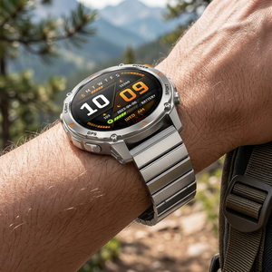 SummitNav GPS smartwatch with a silver steel flat-link bracelet on a wrist near a mountain trail