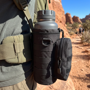 Black MOLLE water bottle pouch with side zip pocket on a hiker's hip belt on a red rock trail
