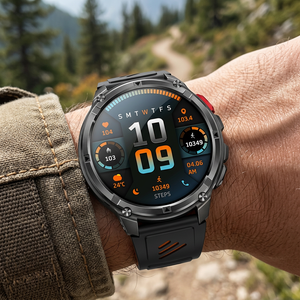 TrailCore outdoor smartwatch with a black and orange silicone band on a wrist near a mountain trail
