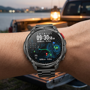 TrailCore outdoor smartwatch with a black steel link bracelet on a wrist at a lakeside campsite