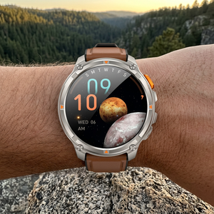 TrailCore outdoor smartwatch with a brown leather band on a wrist at a trail overlook at golden hour