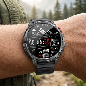 TrailCore outdoor smartwatch with a black steel flat-link bracelet on a wrist near a mountain trail