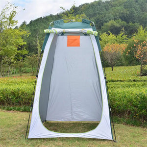 Green HideAway privacy tent set up on grass, door rolled up and tied at the top, gray walls inside